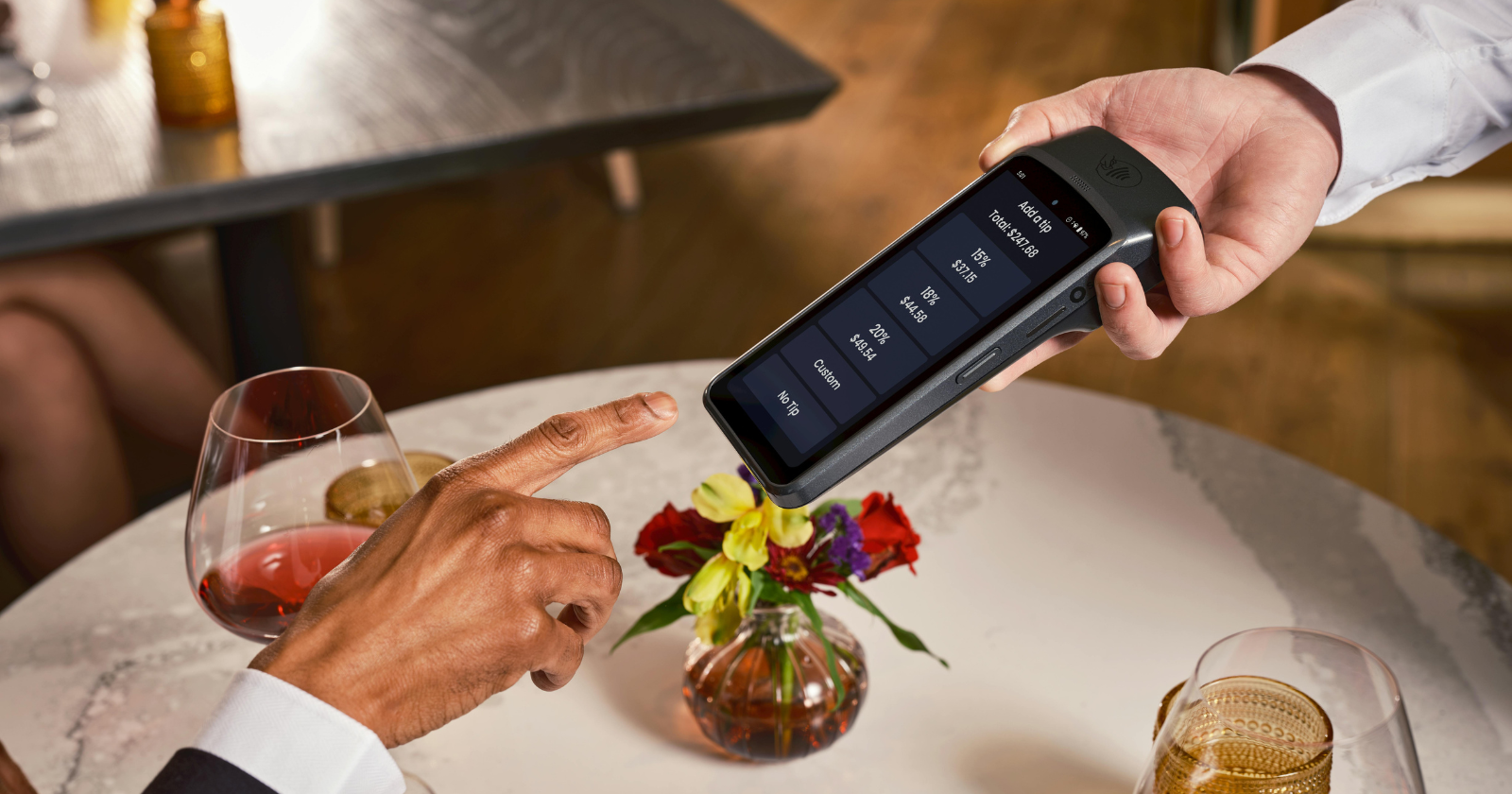 Diner paying with a handheld card terminal
