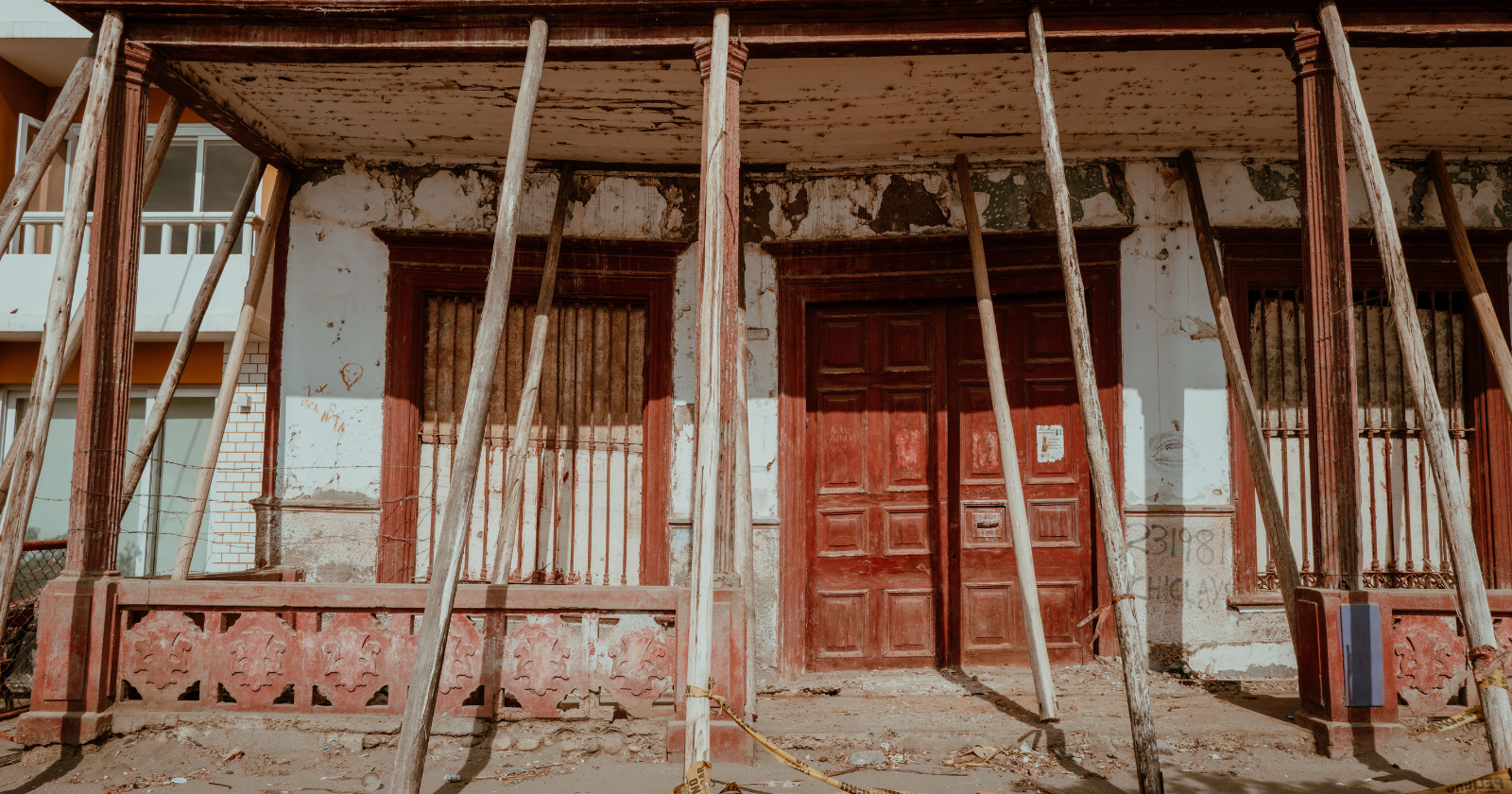 Weathered building facade with red doors