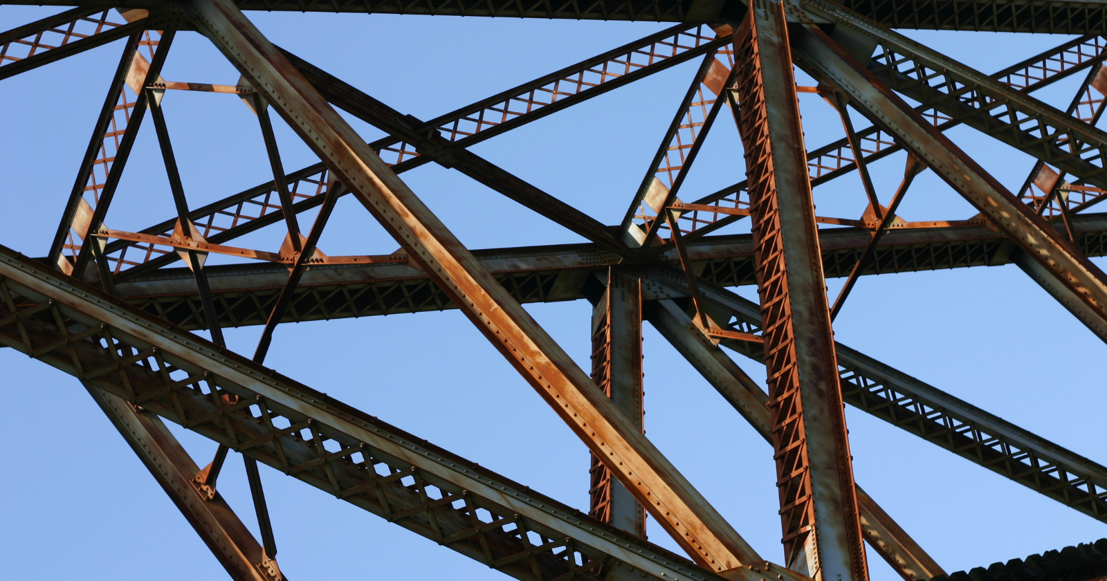 Corroded steel beams and rivets on a bridge