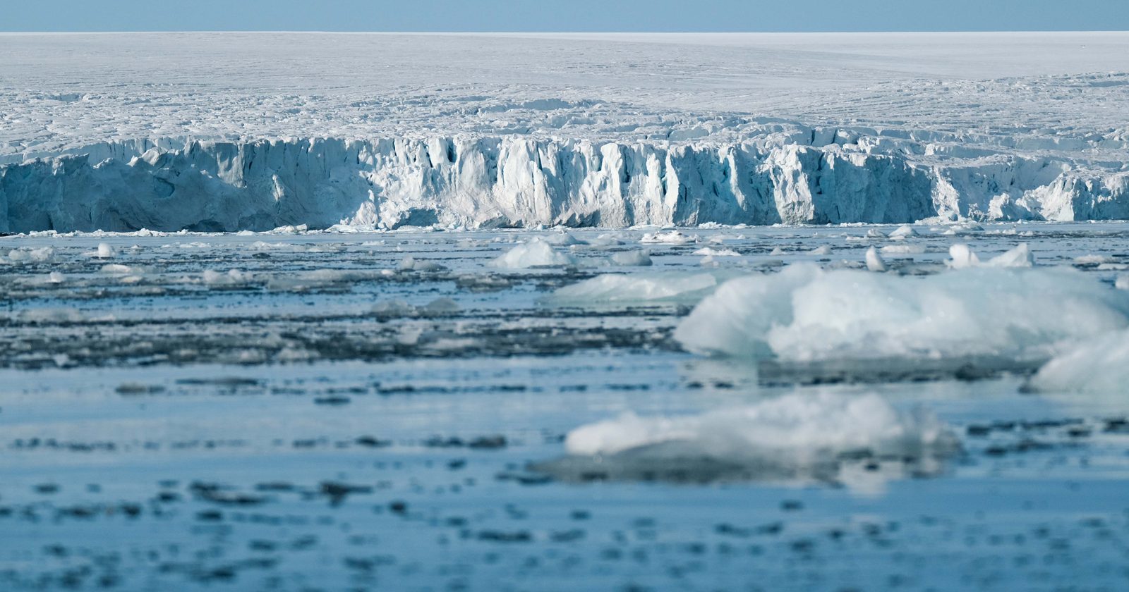 Expansive ice shelf and frozen sea in the Arctic, showcasing the beauty of the natural glacial landscape.