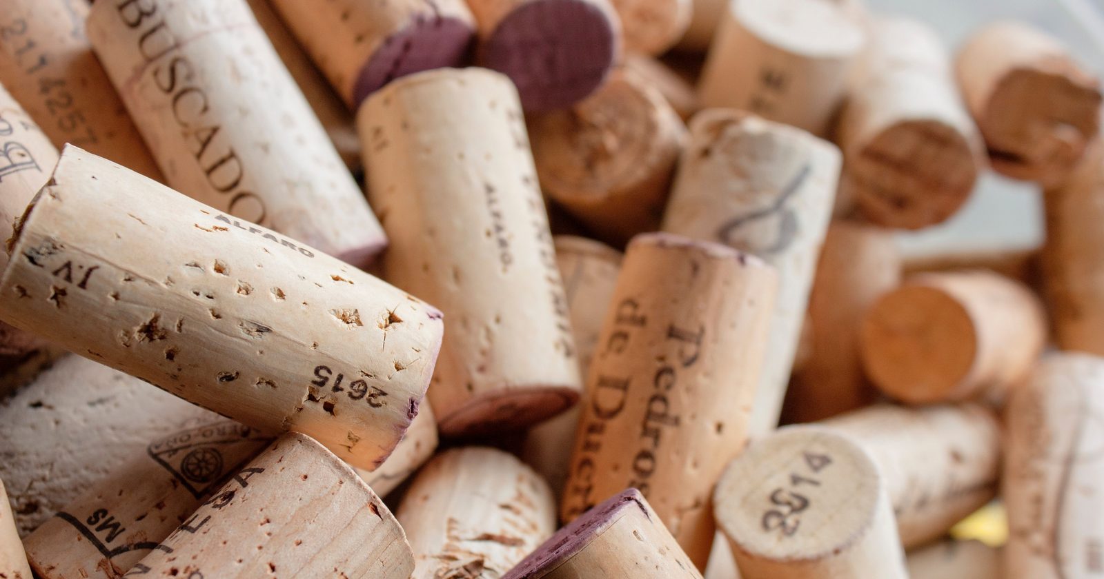 A detailed close-up of various wine corks with visible impressions and textures.