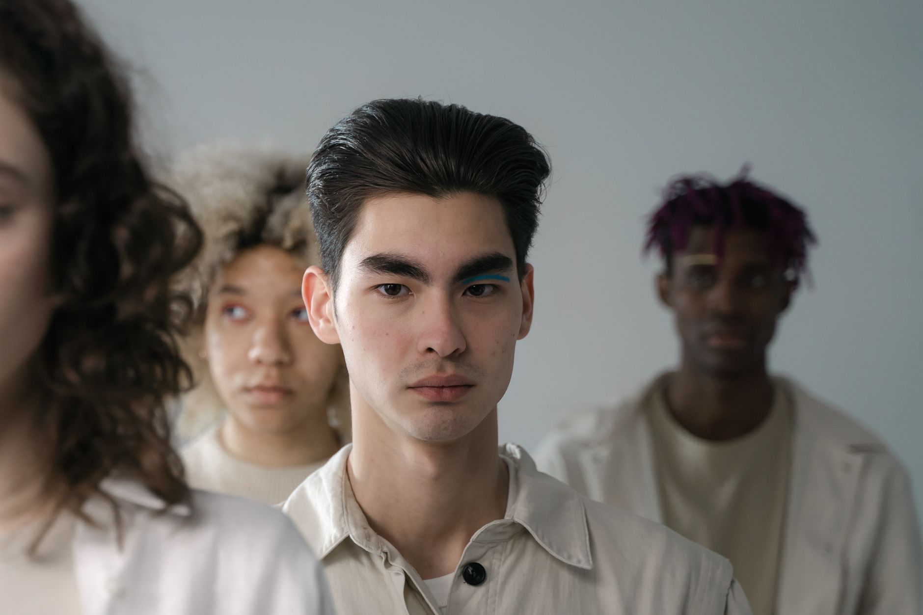 Close-up portrait of four adults standing together