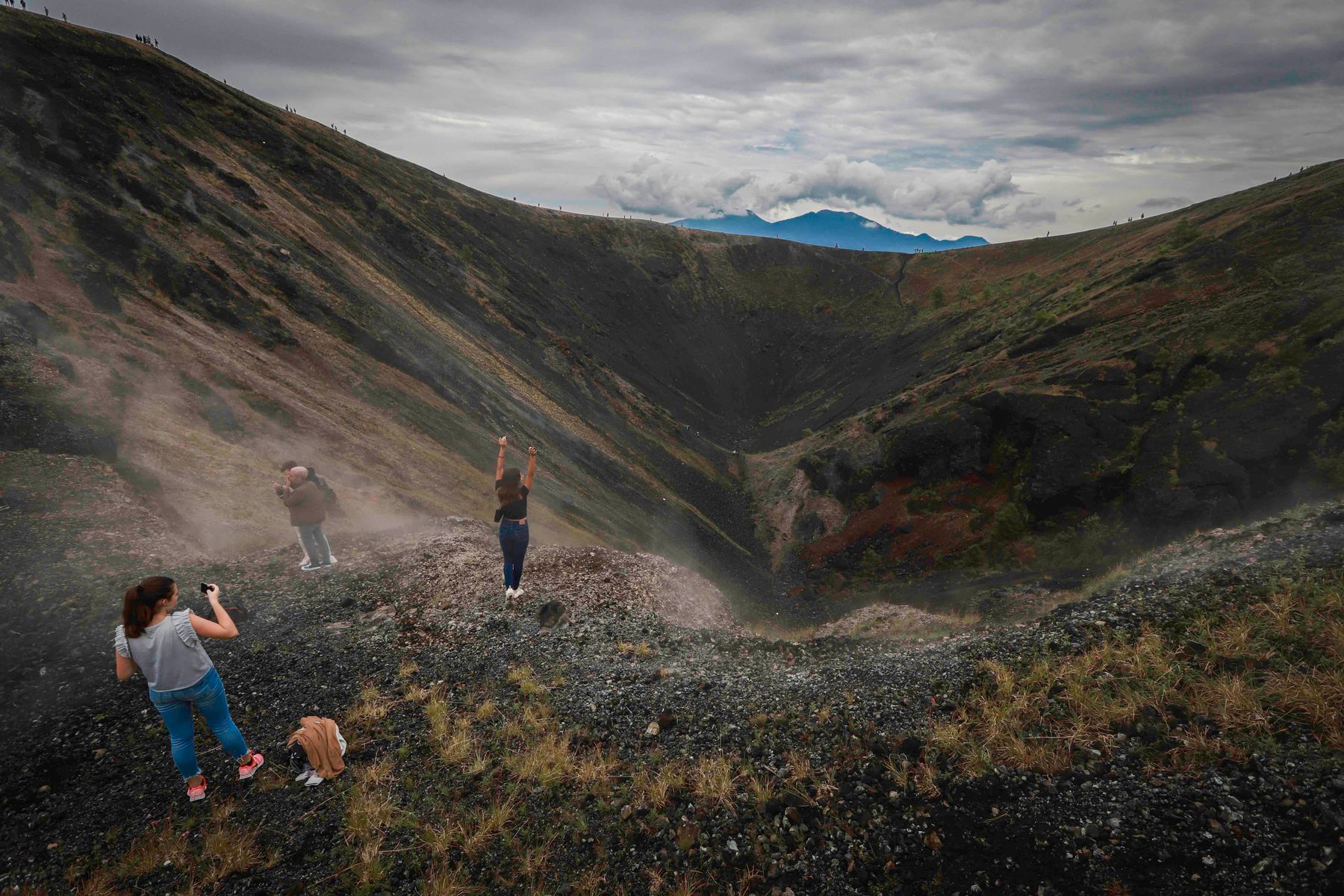Visitors standing inside the crater of Parícutin volcano in Michoacán, Mexico