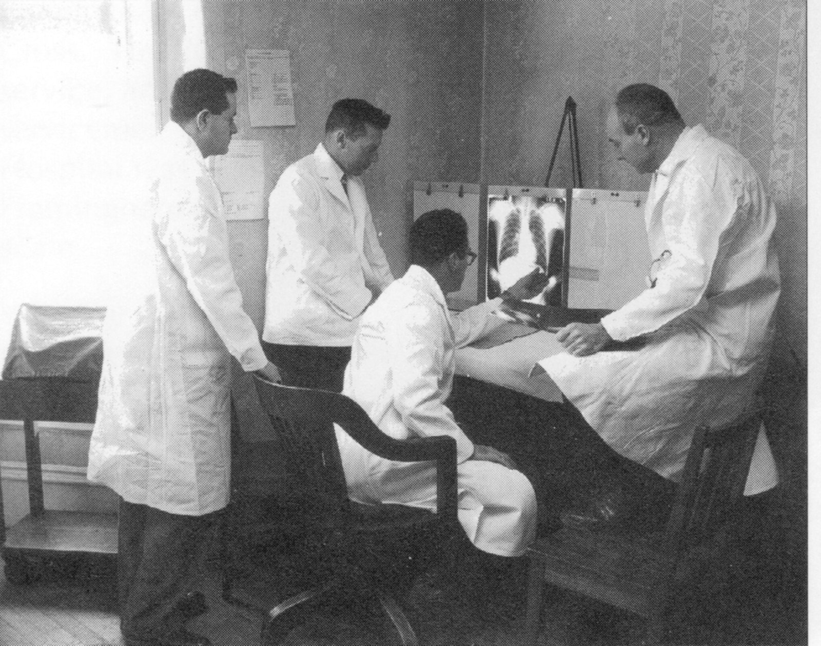 Four Framingham Heart Study physicians in white coats look at chest X-rays on a light box