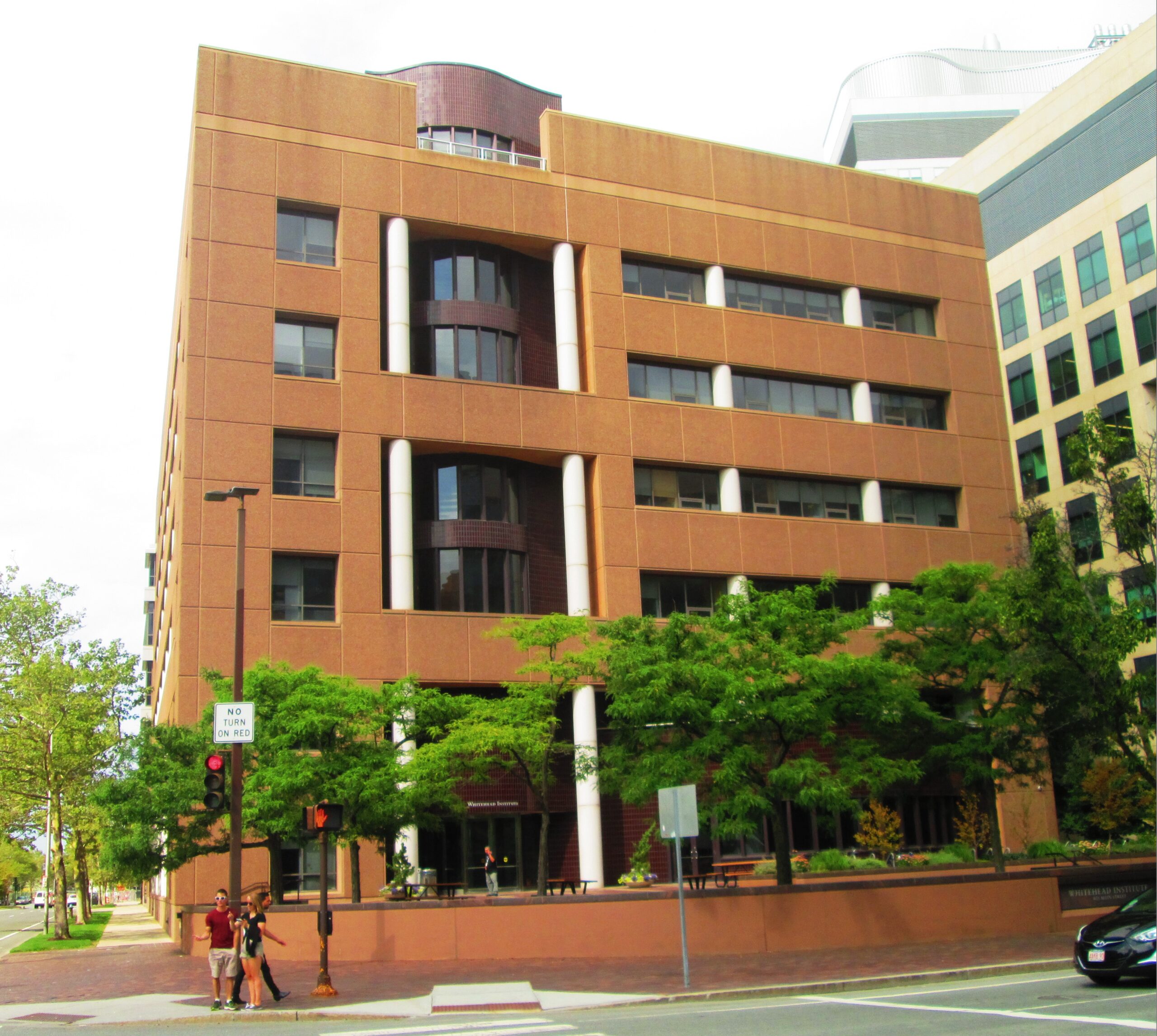 The Whitehead Institute for Biomedical Research building, a brick-clad research block on a Cambridge street corner